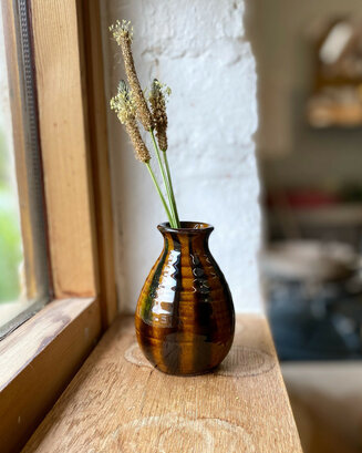 Wheel thrown bud vase in slip decorated terracotta