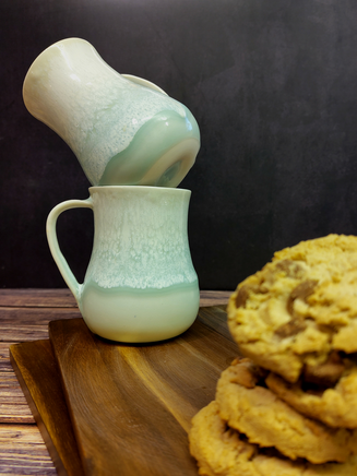 Porcelain mugs with green glaze