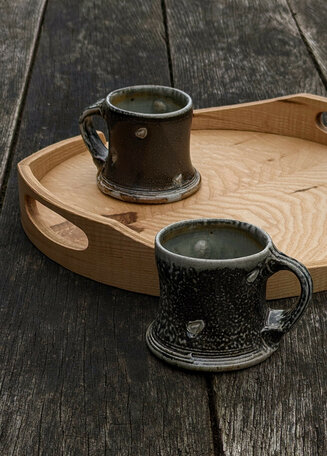 Wood-fired salt-glazed stoneware mugs by Jeremy Steward and ripple ash round tray by Ben Casson