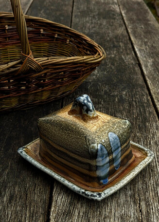 Wood-fired salt-glazed stoneware butterdish by Petra Steward and willow flower basket by Clyde Hoare